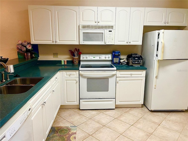 kitchen featuring white cabinets, white appliances, sink, and light tile patterned floors