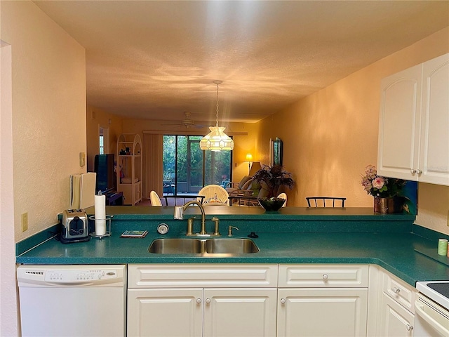 kitchen with decorative light fixtures, sink, white cabinets, kitchen peninsula, and white appliances