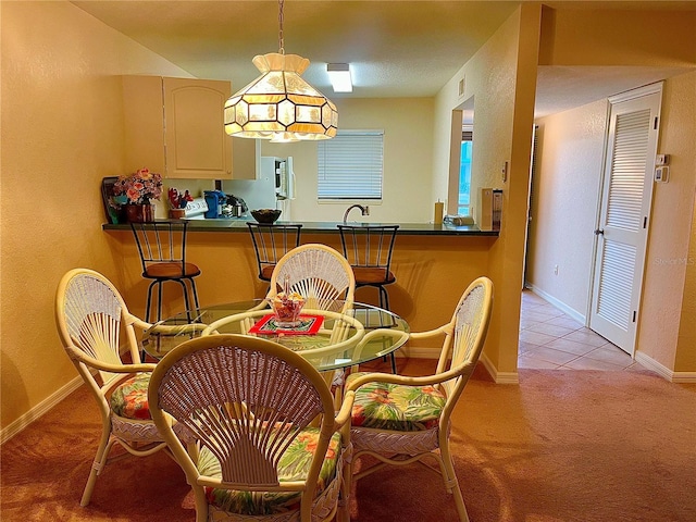 dining area featuring light carpet