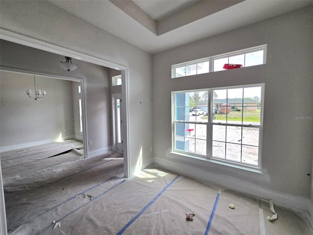 foyer with an inviting chandelier and baseboards