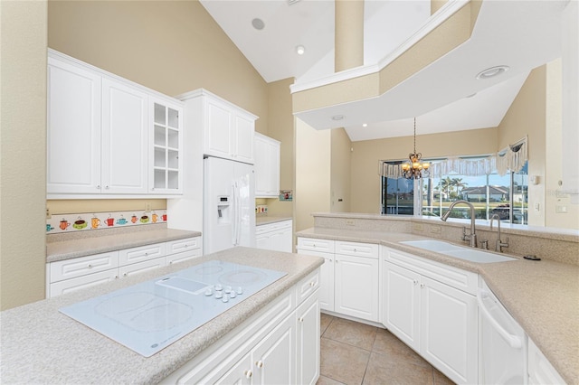 kitchen with white cabinetry, sink, white appliances, and high vaulted ceiling