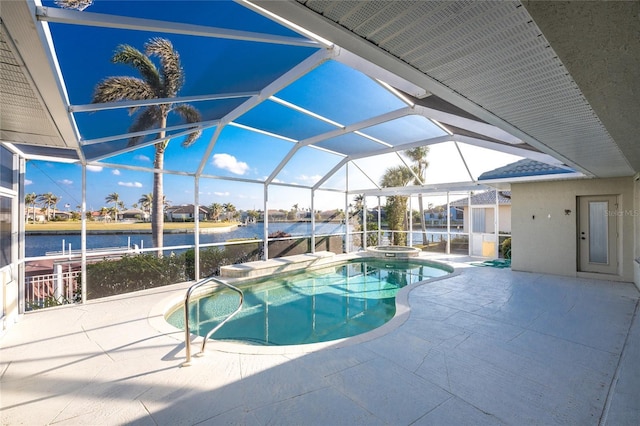 view of pool with a water view, a patio area, glass enclosure, and an in ground hot tub