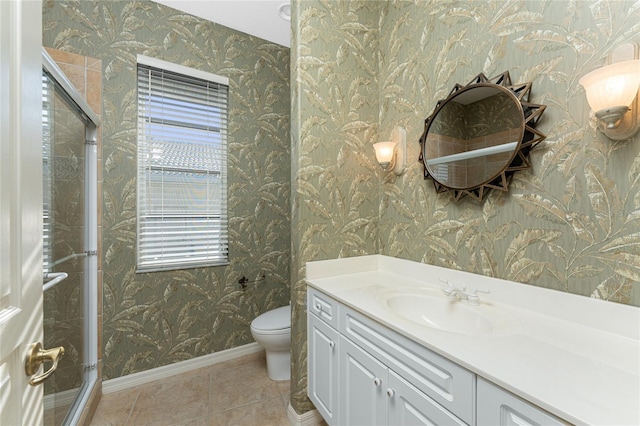 bathroom featuring toilet, vanity, tile patterned floors, and a wealth of natural light