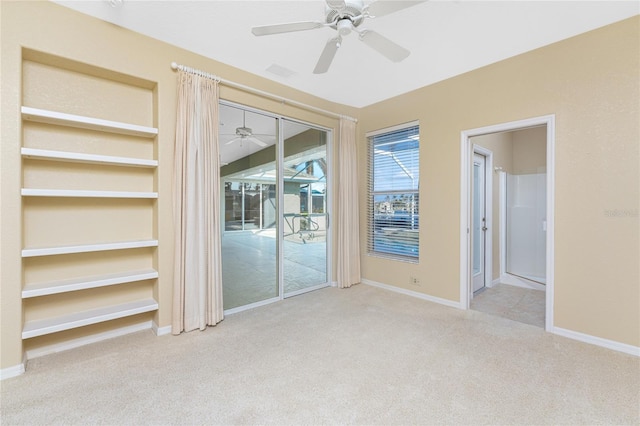 empty room with ceiling fan and light colored carpet