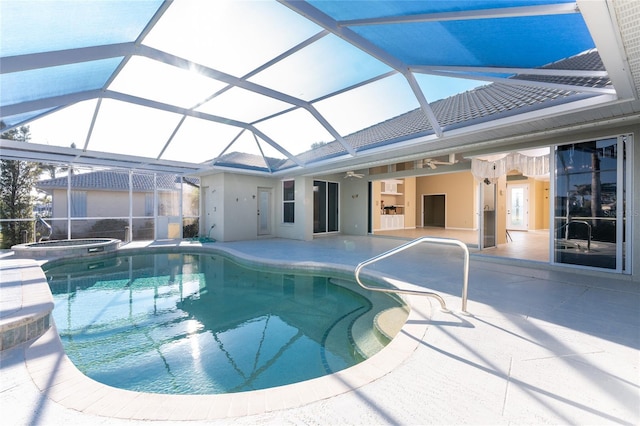 view of pool with ceiling fan, a patio, glass enclosure, and an in ground hot tub