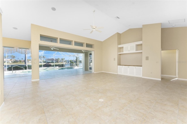 unfurnished living room featuring ceiling fan and vaulted ceiling