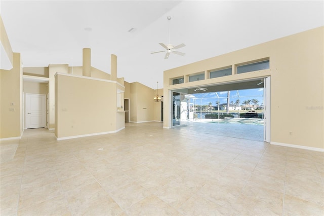 unfurnished living room featuring ceiling fan and high vaulted ceiling