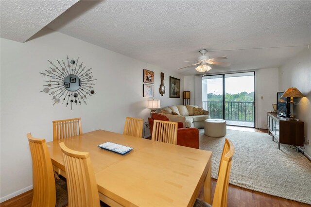 dining area featuring ceiling fan, a textured ceiling, and hardwood / wood-style floors