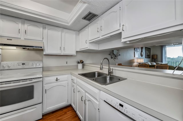 kitchen with dark hardwood / wood-style floors, sink, white appliances, and white cabinetry