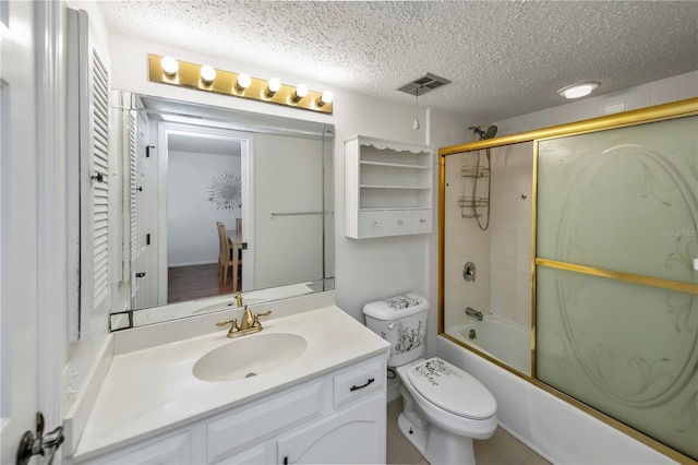 full bathroom featuring toilet, enclosed tub / shower combo, vanity, and a textured ceiling