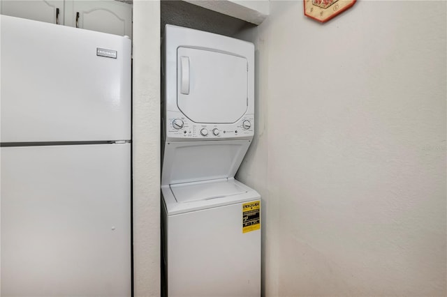 laundry room with stacked washer / drying machine