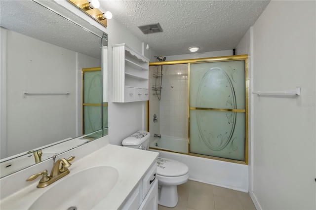 full bathroom featuring toilet, bath / shower combo with glass door, tile patterned flooring, a textured ceiling, and vanity