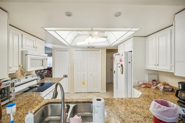 kitchen with sink, white appliances, white cabinetry, and ceiling fan