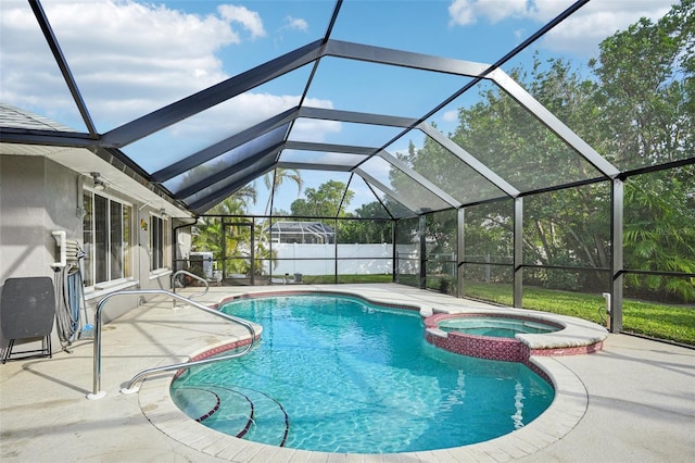 view of swimming pool with a lanai, an in ground hot tub, and a patio