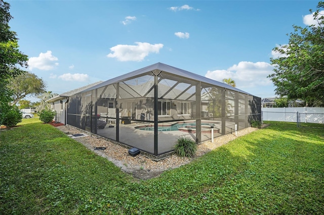 view of swimming pool featuring a lanai, a patio area, and a lawn