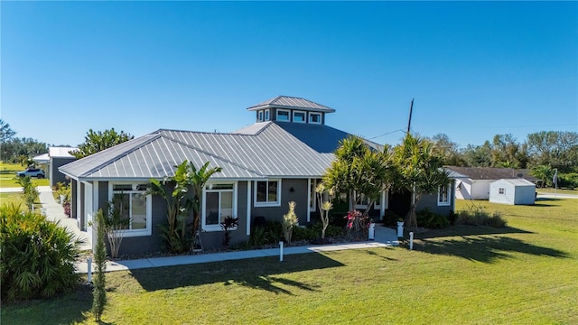 view of front facade with a front yard and a shed