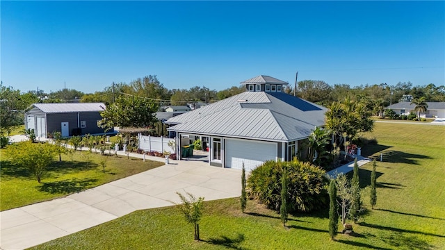 view of front of house featuring a garage and a front lawn