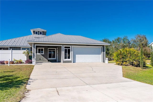 view of front of home with a front lawn and a garage