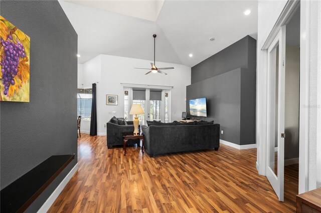 living room with ceiling fan, french doors, vaulted ceiling, and hardwood / wood-style flooring