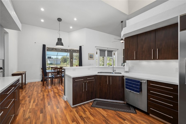 kitchen with decorative light fixtures, dark hardwood / wood-style flooring, sink, ceiling fan, and stainless steel dishwasher