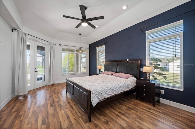 bedroom featuring ceiling fan, dark wood-type flooring, multiple windows, and access to outside