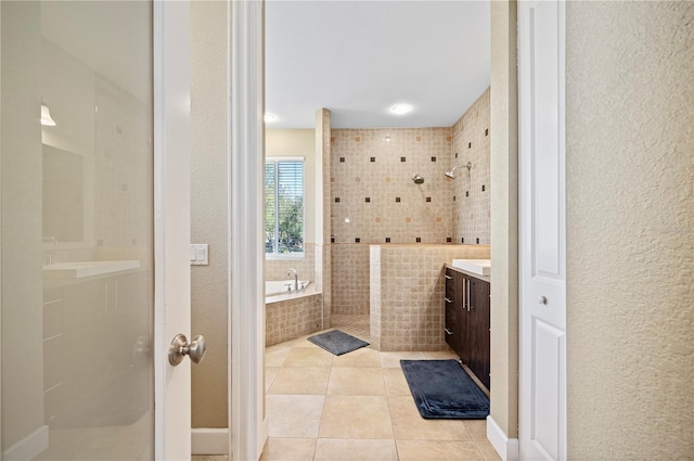 bathroom featuring tile patterned floors, vanity, and plus walk in shower