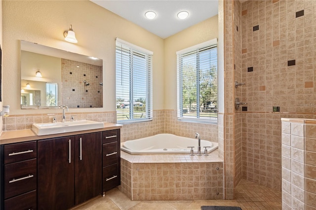 bathroom featuring vanity, tile patterned flooring, and shower with separate bathtub