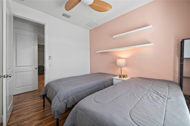 bedroom with ceiling fan and dark hardwood / wood-style flooring