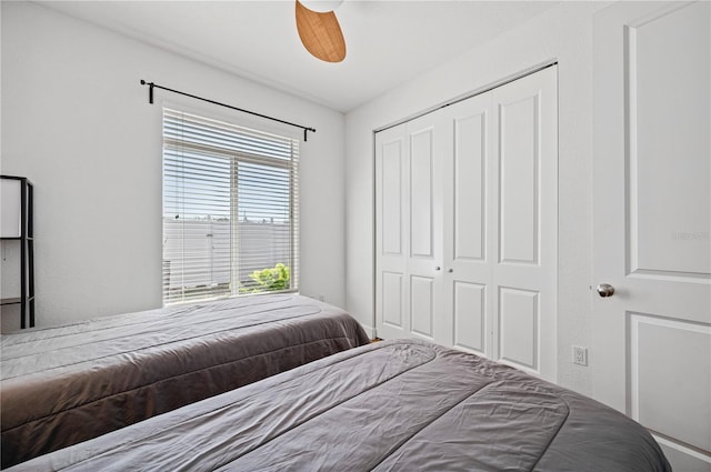 bedroom with a closet, multiple windows, and ceiling fan