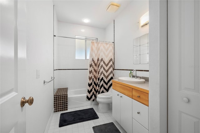 full bathroom with toilet, vanity, tile patterned flooring, and shower / tub combo with curtain