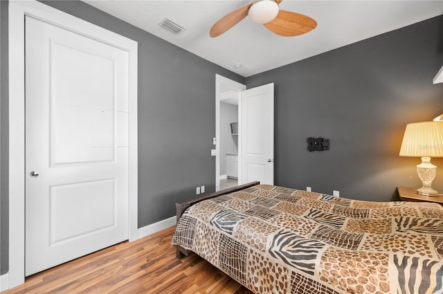 bedroom with ceiling fan, wood-type flooring, and a closet