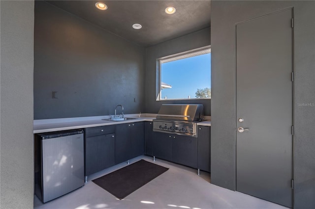 kitchen with stainless steel fridge and sink