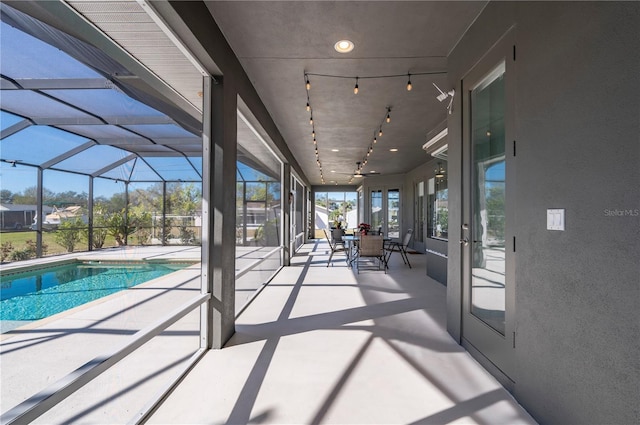 view of swimming pool featuring a patio area and a lanai