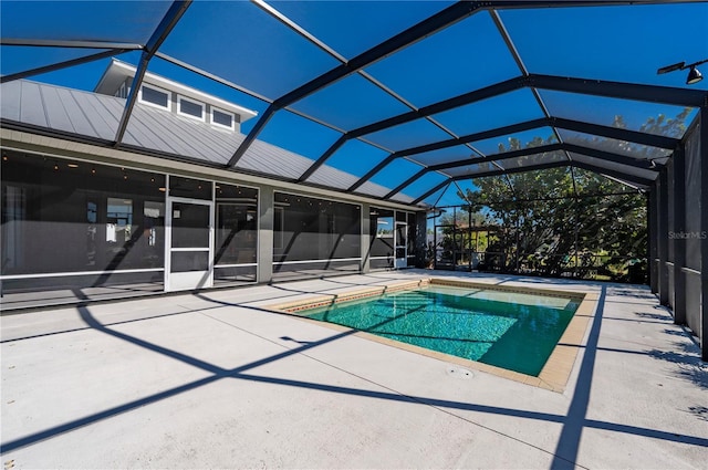 view of swimming pool featuring a lanai and a patio area