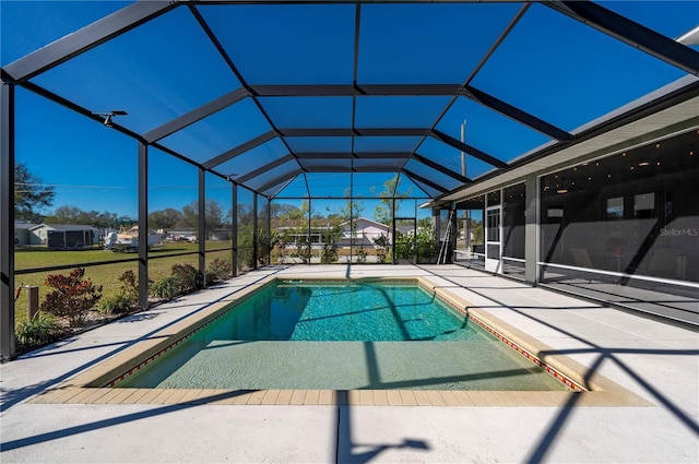 view of pool featuring glass enclosure and a patio