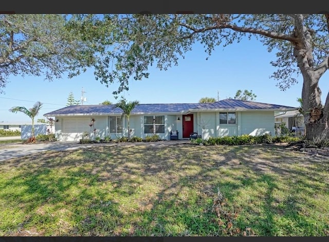 ranch-style home with a front lawn and a garage