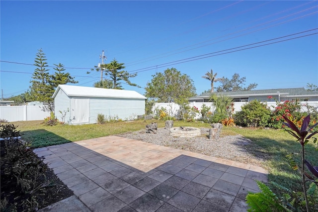 view of patio / terrace featuring a fire pit and an outdoor structure