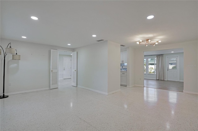 empty room featuring an inviting chandelier