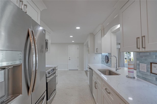 kitchen with white cabinets, stainless steel appliances, and tasteful backsplash