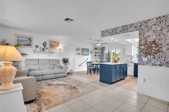 living room with light tile patterned floors and ceiling fan