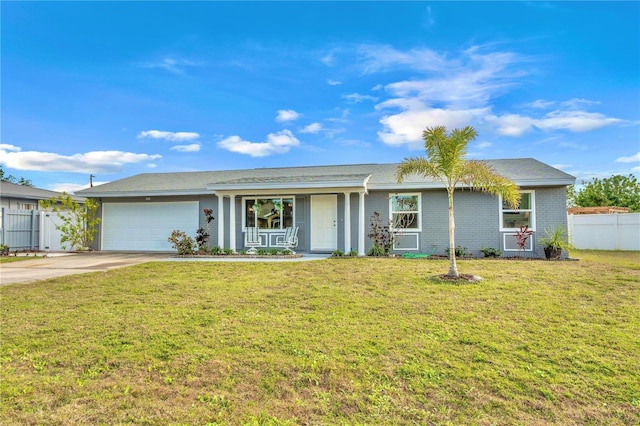 ranch-style house featuring a front lawn and a garage