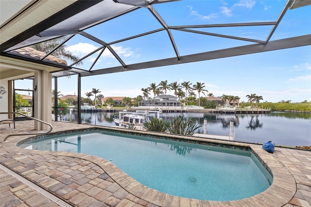 view of pool with a patio area, a lanai, and a water view