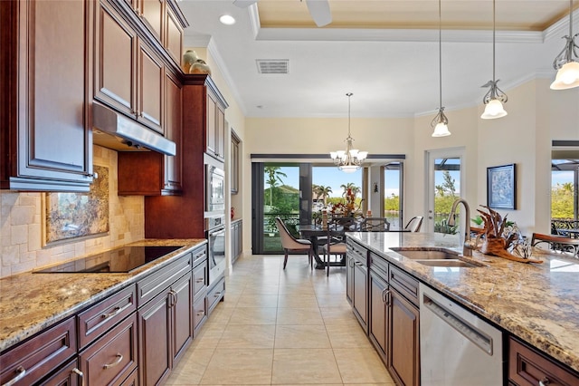 kitchen with sink, crown molding, appliances with stainless steel finishes, light stone countertops, and decorative light fixtures