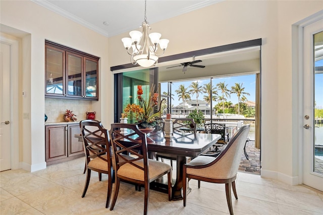 dining space featuring ornamental molding and an inviting chandelier