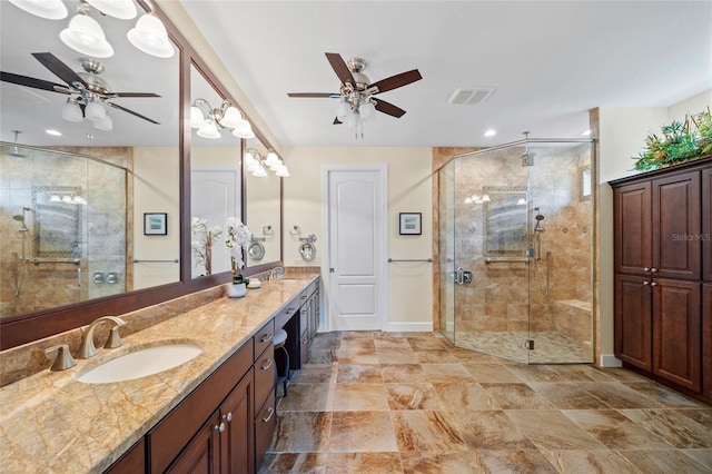 bathroom featuring ceiling fan, vanity, and an enclosed shower