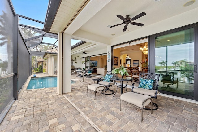 view of patio with glass enclosure and ceiling fan