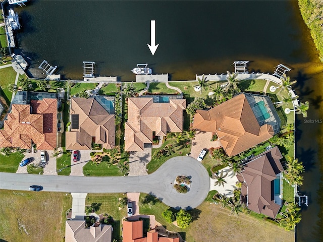 birds eye view of property with a water view