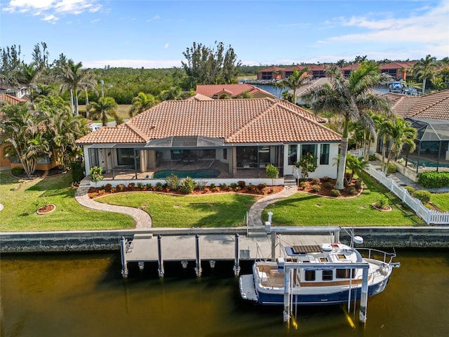 rear view of property featuring a yard, a lanai, and a water view