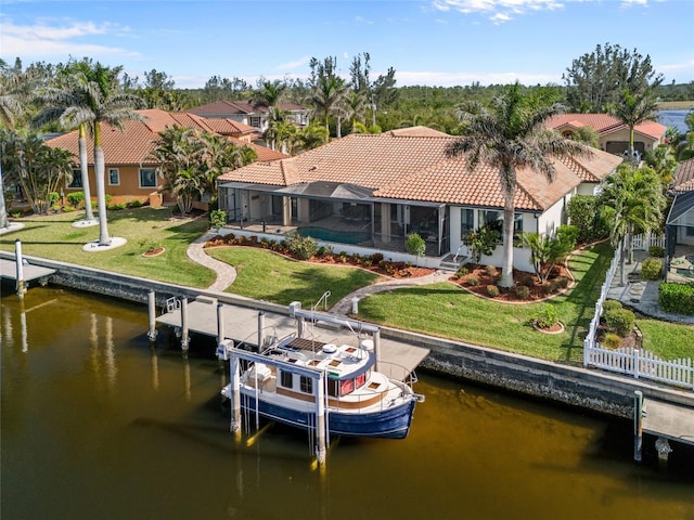 dock area featuring a lanai, a water view, and a yard