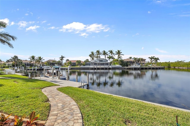 view of dock featuring a water view and a yard